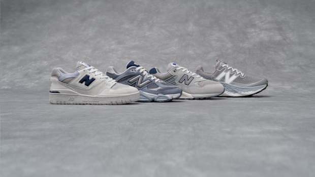 Side view of four grey New Balance sneakers.